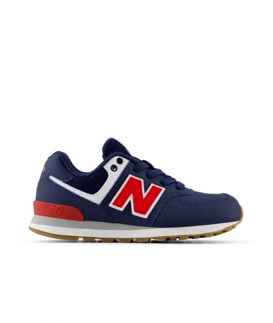 Navy blue New Balance 574 Core Lace little kids' sneaker with a red 'N' logo, white trim, red heel accent, and brown sole.