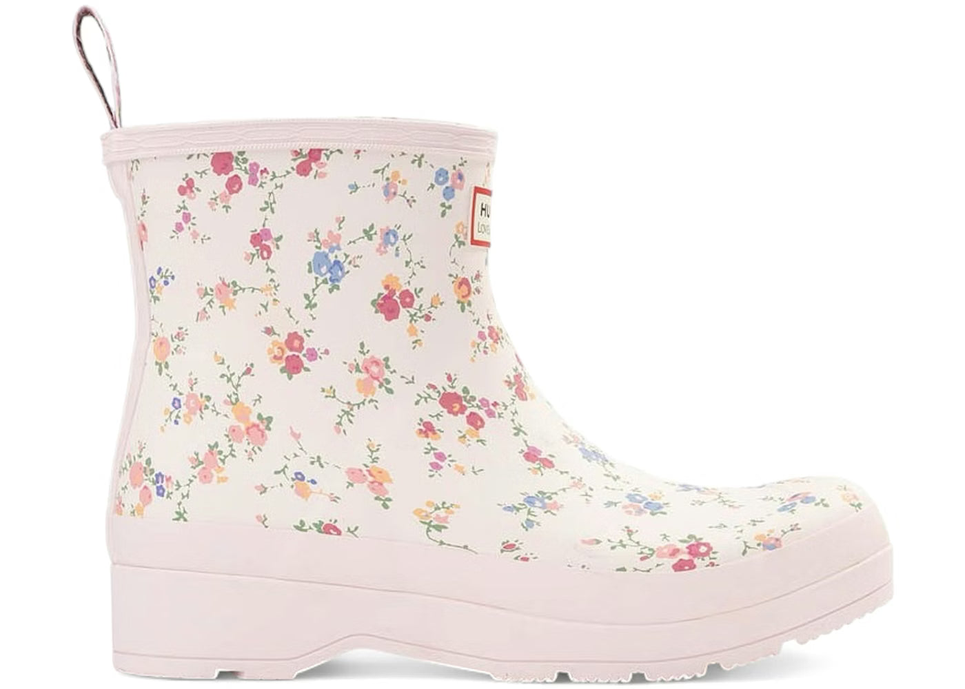 White Hunter x LoveShackFancy short rain boot with a multi-colored floral pattern, light pink trim, and a pull tab.