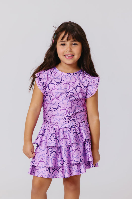 Terez Girls Hi-Shine Ruffle Crop Top in Purple Bows on model
