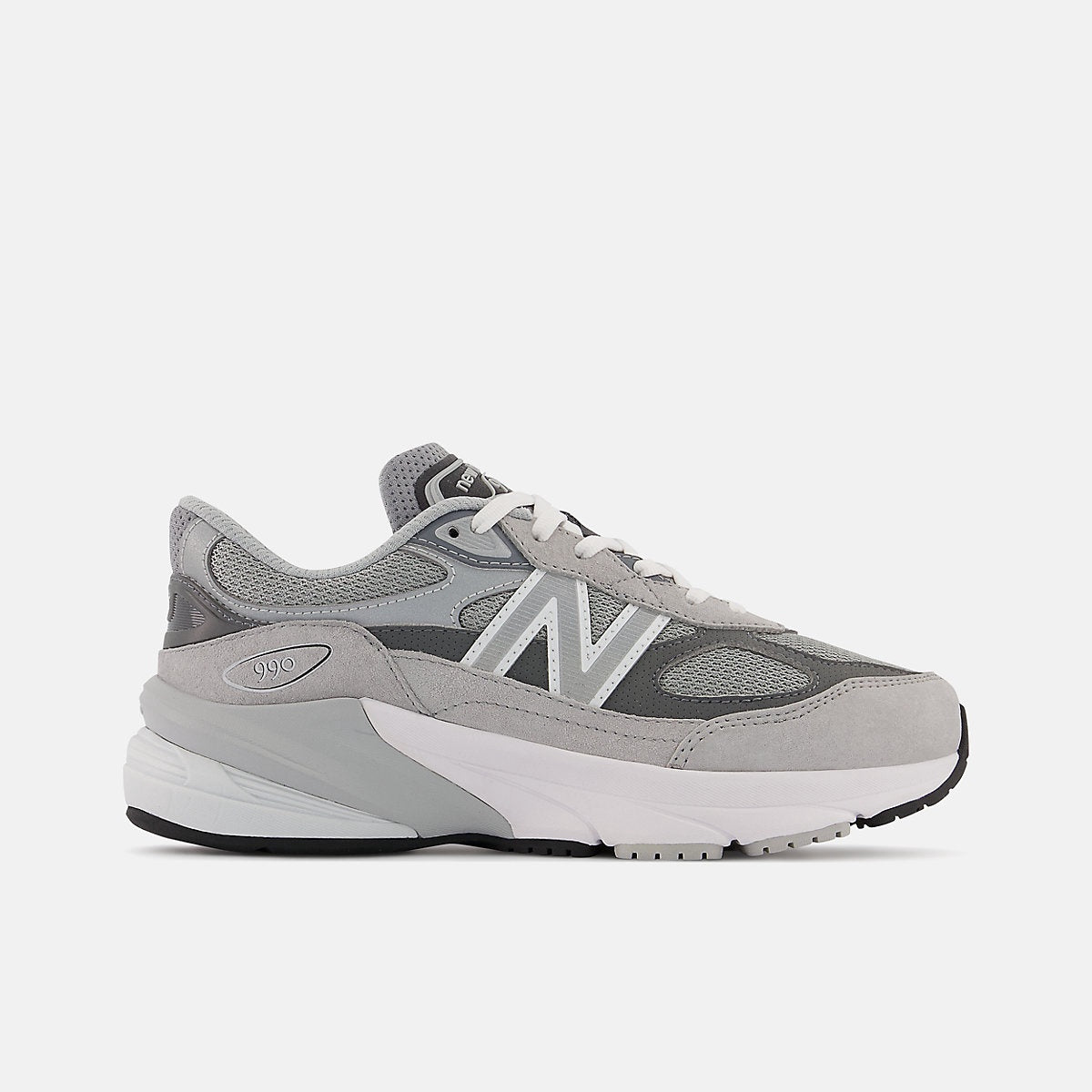 New Balance Fuelcell 990v6 Big Kids sneaker in shades of gray with white laces and sole, featuring the iconic 'N' logo and '990' on the heel.