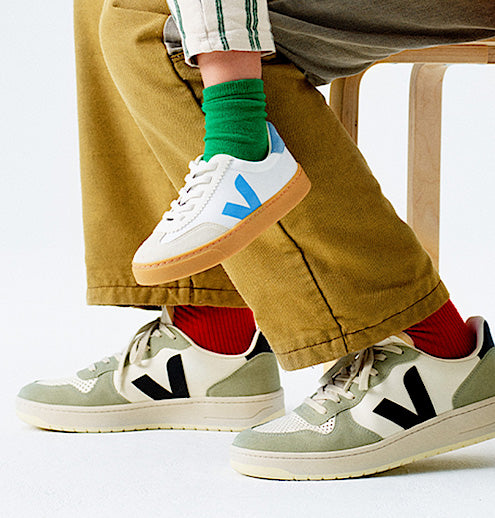 Group of bigger kids in sneakers against a white wall