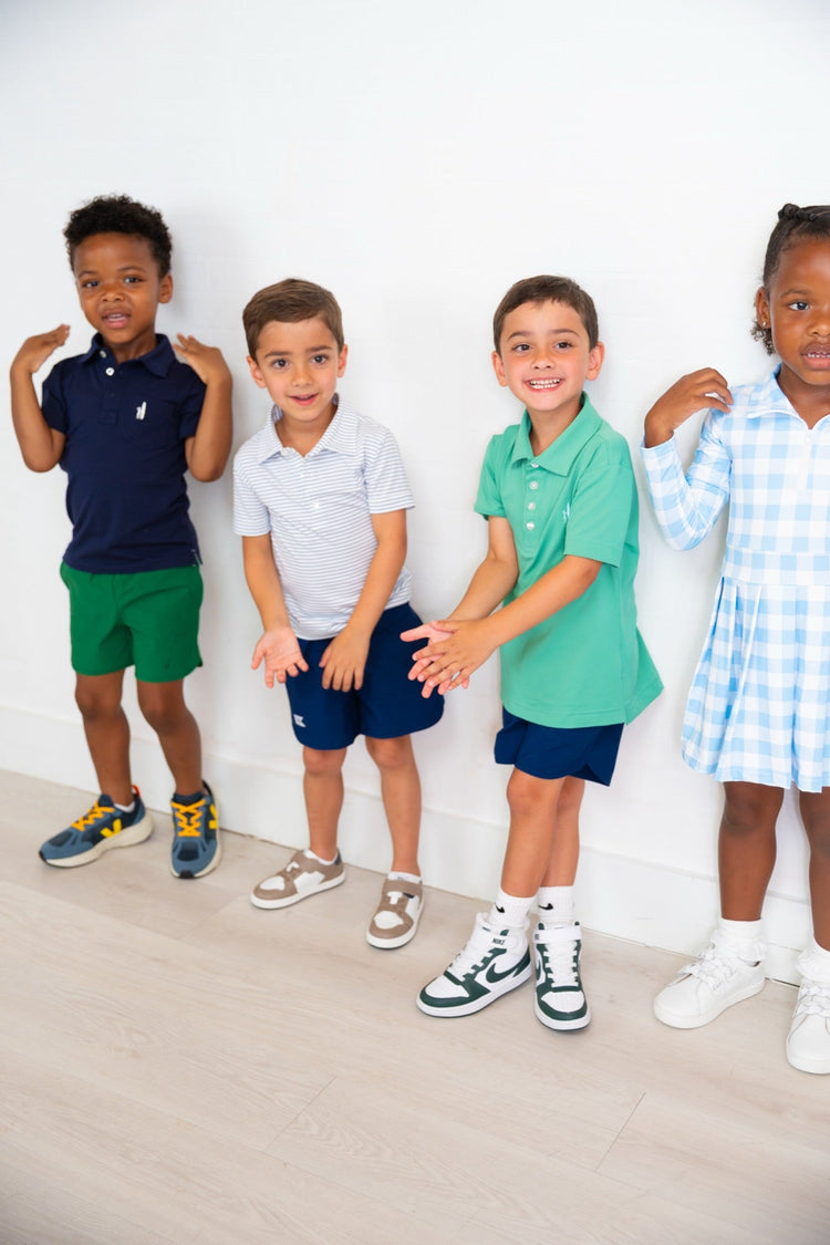 Group of bigger kids in sneakers against a white wall