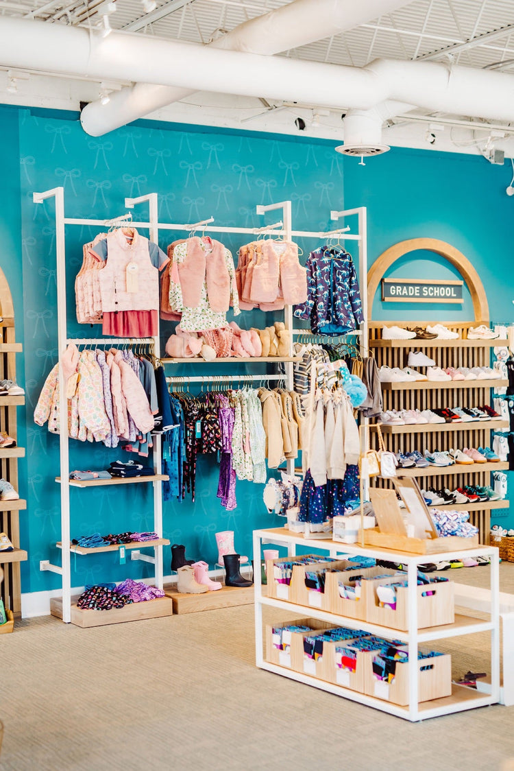 Store apparel display with jackets and rain boots