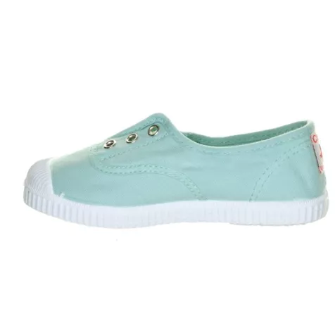Mint green canvas slip-on sneaker with a ribbed white rubber toe cap and sole, featuring four silver eyelets and a small red heel tag.
