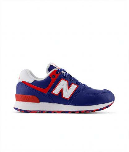 New Balance 574 Core Lace little kids' sneaker in blue with red accents, white 'N' logo, white midsole, and patterned outsole.