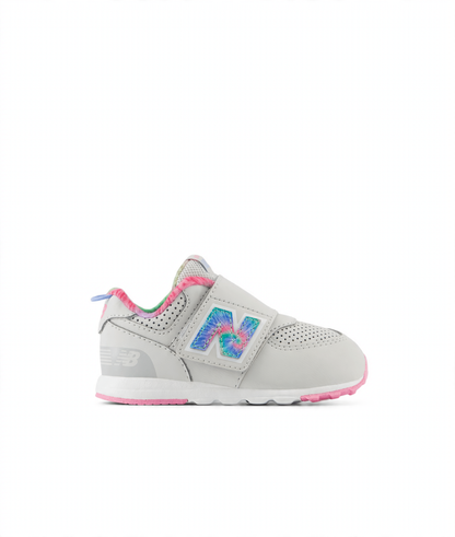 Light gray New Balance 574 children's sneaker with a tie-dye 'N' logo, pink accents, and a hook-and-loop closure.