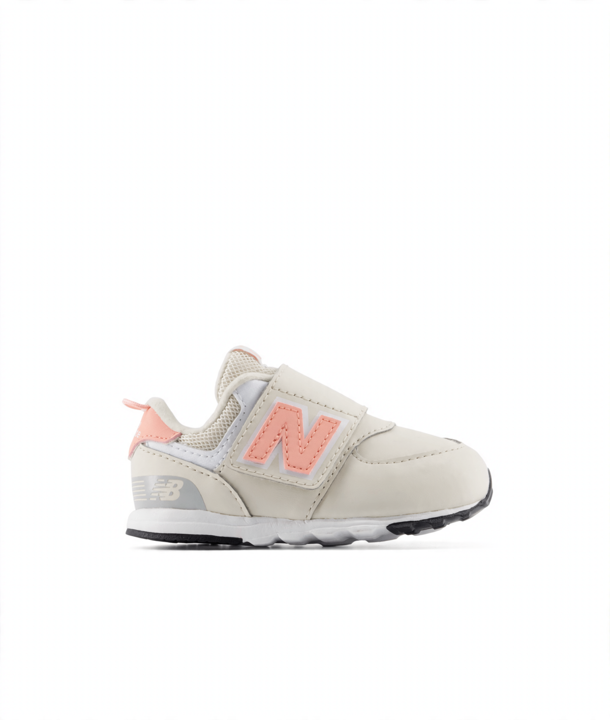 Toddler New Balance 574 sneaker in cream with a light pink 'N' logo, hook-and-loop strap, and white accents.