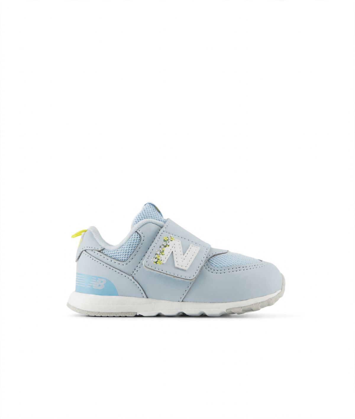 Light blue New Balance 574 children's sneaker with hook & loop closure, white N logo with floral details, and yellow heel tab.