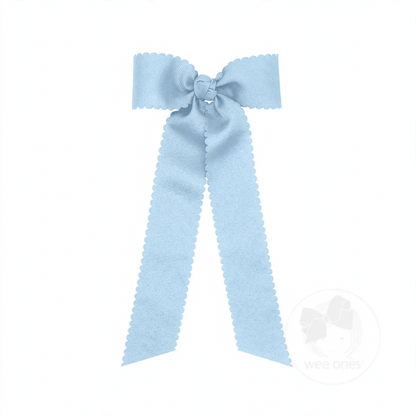 Light blue grosgrain hair bow with scalloped edges, a knot wrap center, and long streamer tails.