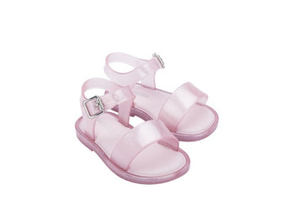 Pair of translucent pink jelly sandals for babies with silver buckles and ankle straps.