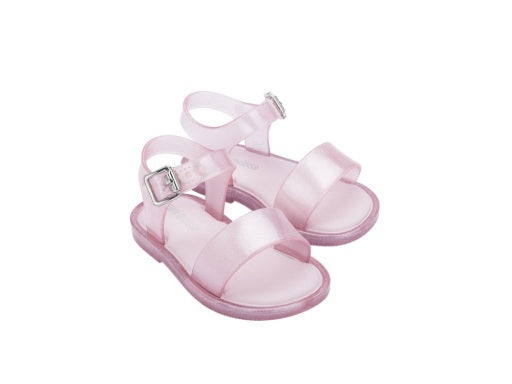 Pair of translucent pink jelly sandals for babies with silver buckles and ankle straps.