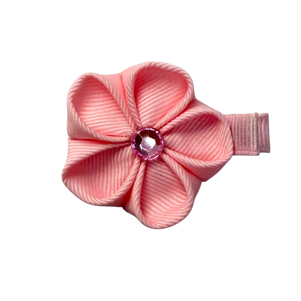 Pink flower-shaped hair clip with a faceted pink gem in the center, made from ribbed ribbon, on a white background.