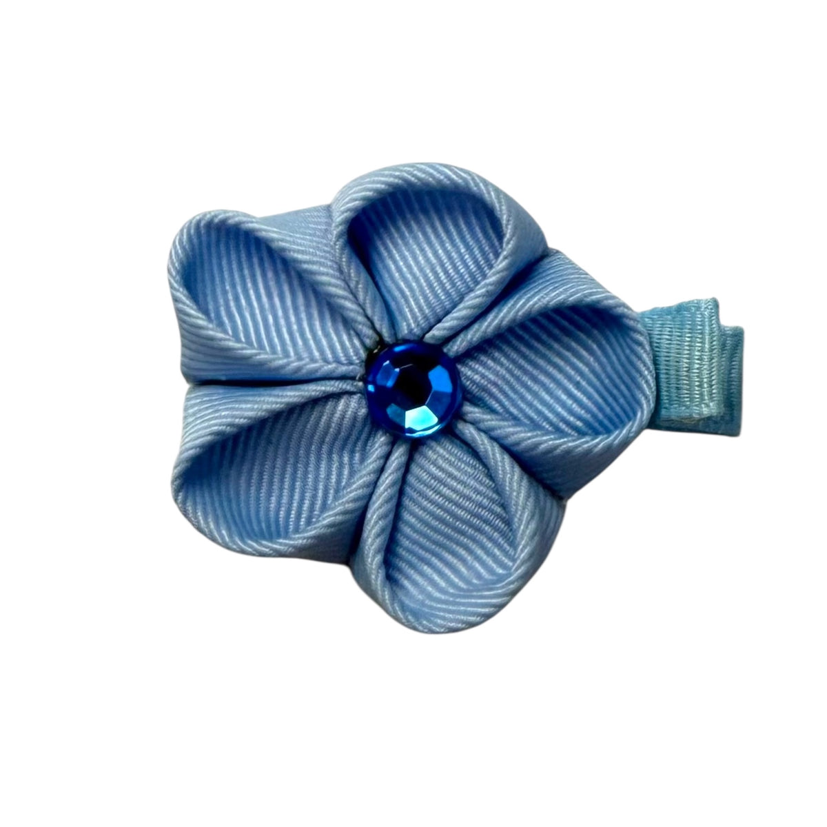 Light blue fabric flower hair clip with a faceted dark blue gem in the center, attached to a small light blue ribbon clip.