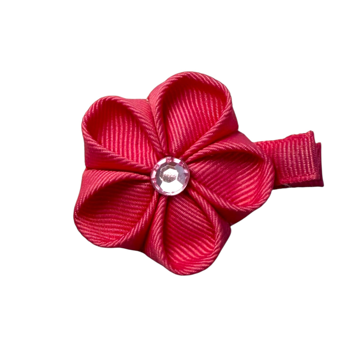 Pink grosgrain ribbon flower hair clip with a clear faceted gem in the center, attached to a small clip on the right side.