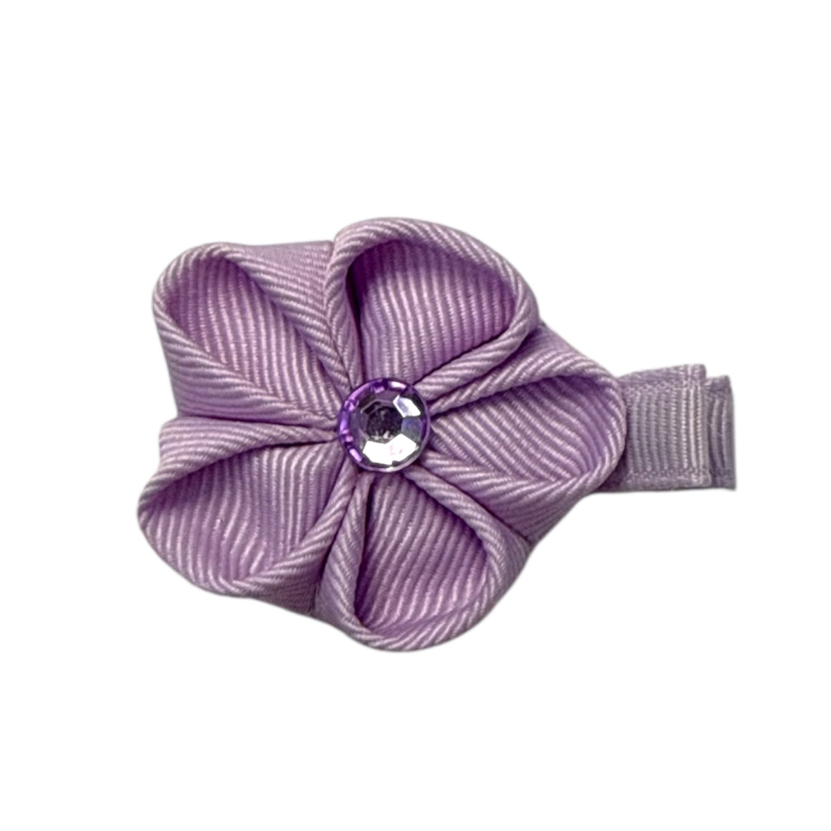 Lavender ribbed ribbon flower hair clip with a faceted purple gem center, attached to a small clip.