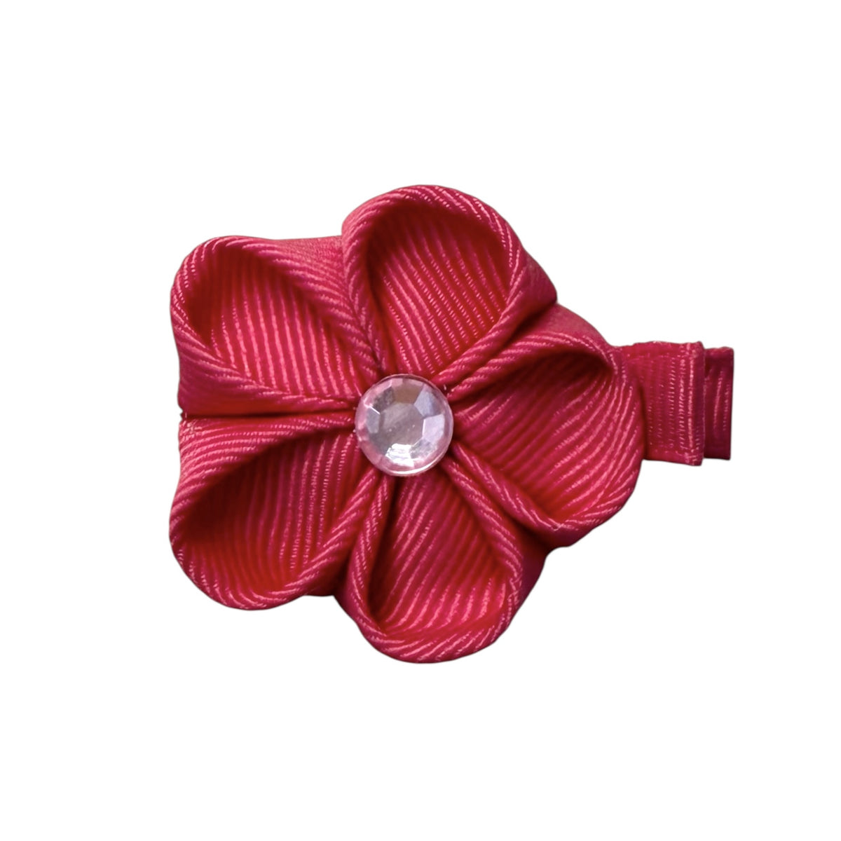 Fuchsia pink fabric flower clip with a ribbed texture and a clear faceted gem in the center.