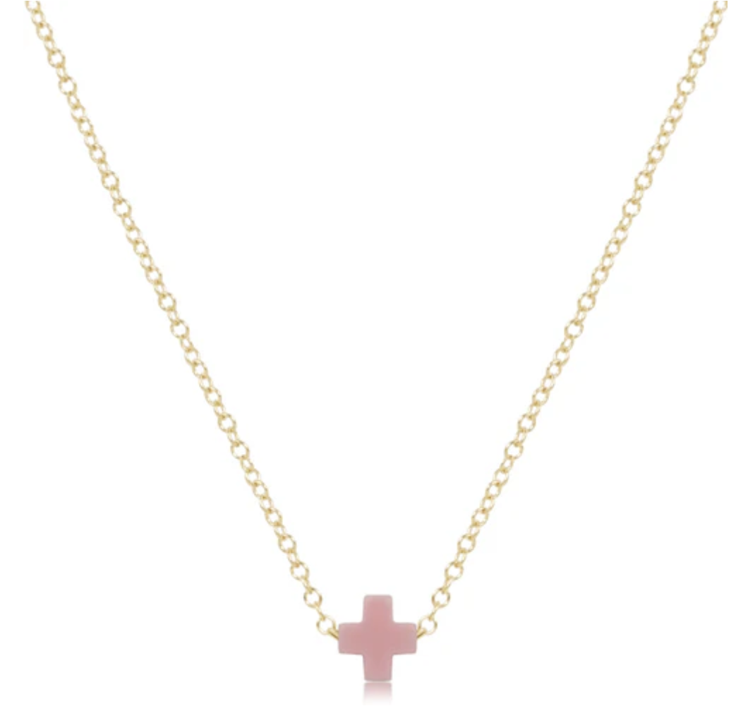 Delicate gold chain necklace with a small, light pink cross pendant centered at the bottom.