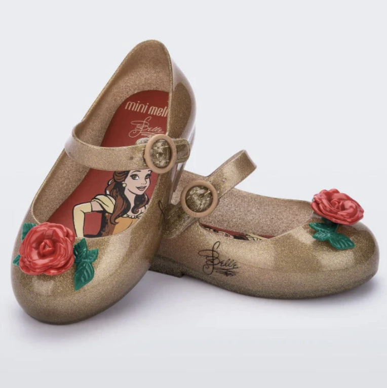 Sparkly gold Mary Jane style shoes with red rose accents, featuring Disney's Belle on the insole and a signature on the side.