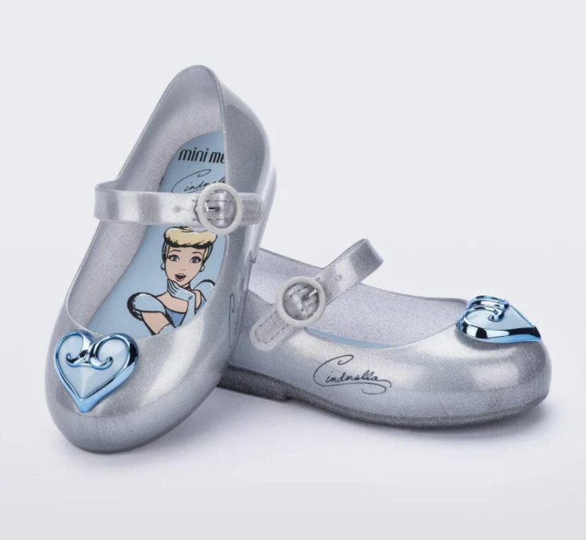 Silver glitter Mini Melissa children's Mary Jane flats featuring light blue Cinderella insoles and distinct blue toe embellishments.