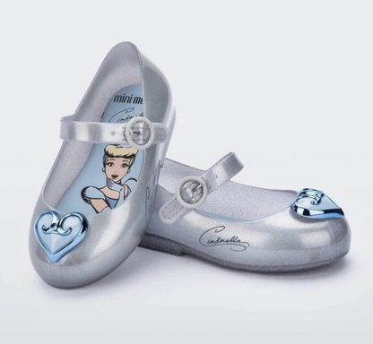 Silver glitter Mini Melissa children's Mary Jane flats featuring light blue Cinderella insoles and distinct blue toe embellishments.