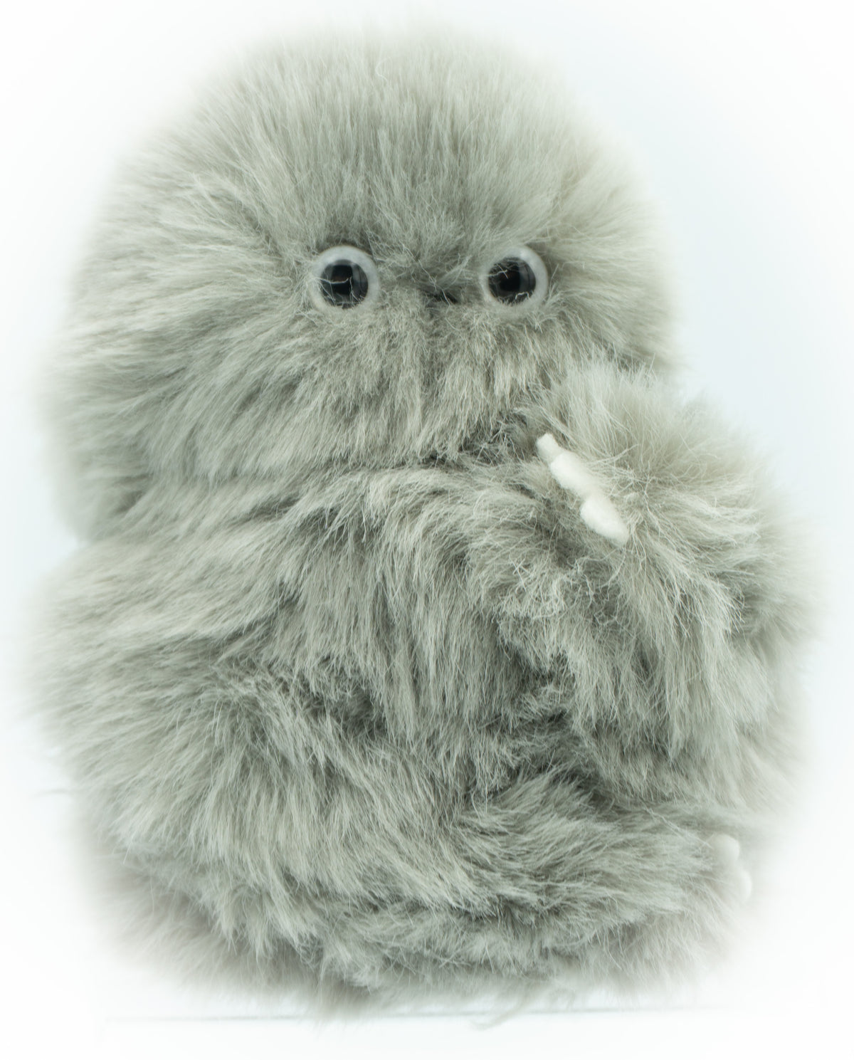 A fluffy gray robotic plush toy with large black eyes and small white claws, photographed against a plain white background.