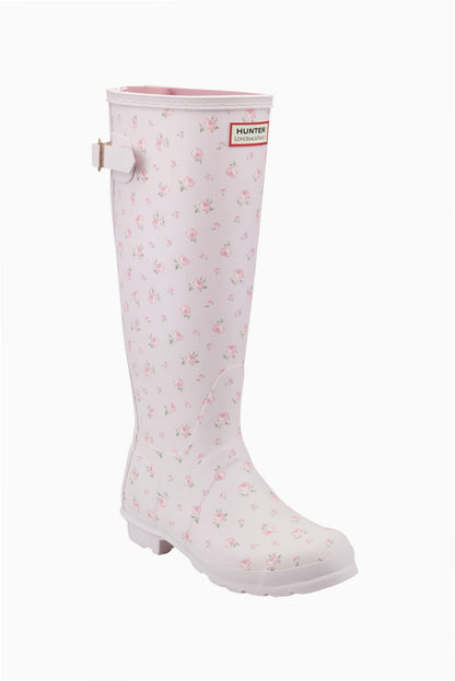 Light pink Hunter x LoveShackFancy tall rain boot with a delicate pink rose floral pattern and an adjustable back buckle.