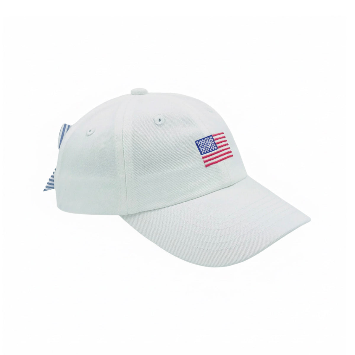 White baseball hat with an embroidered American flag on the front and a blue and white striped bow on the back.