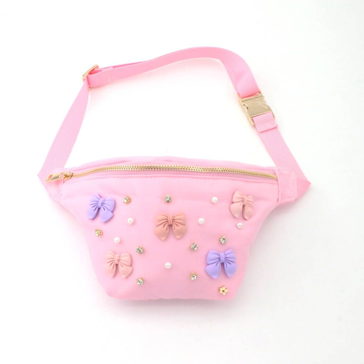 Pink children's fanny pack with a gold zipper and buckle, adorned with pastel bows, white pearls, and sparkling rhinestones.