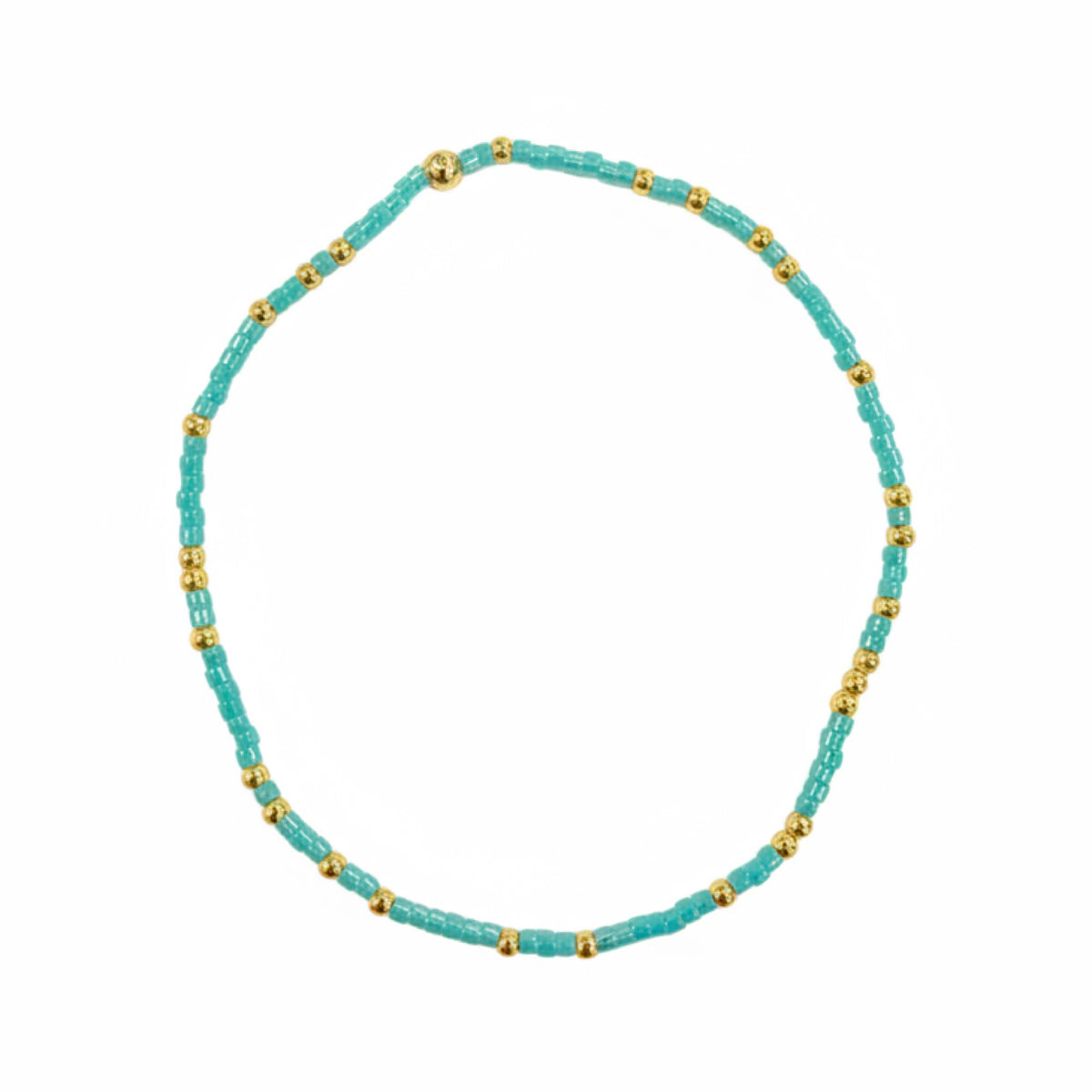 Turquoise beaded bracelet with small gold beads interspersed, forming a circular shape on a white background.