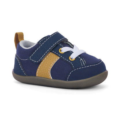 Navy blue and gold first walker shoe with a single hook-and-loop strap, white laces, and a brown sole.