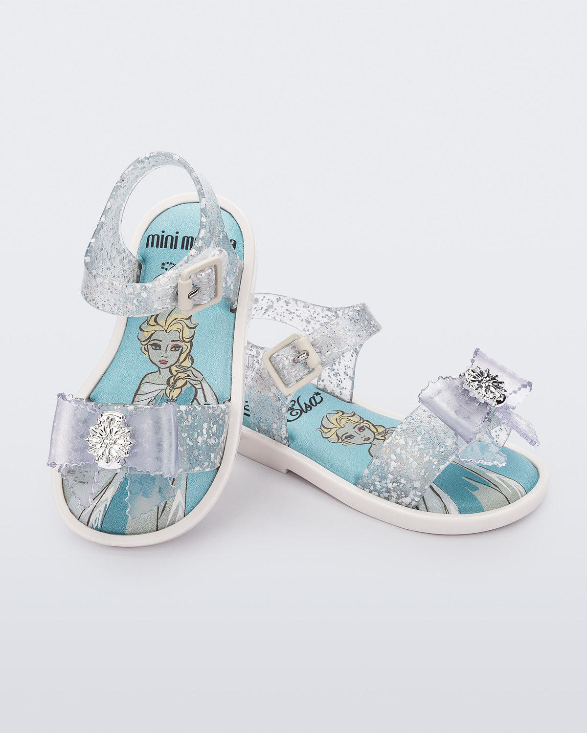 Mini Melissa Mar Disney Princess baby sandals in Glitter Clear/White with Elsa artwork and snowflake bow