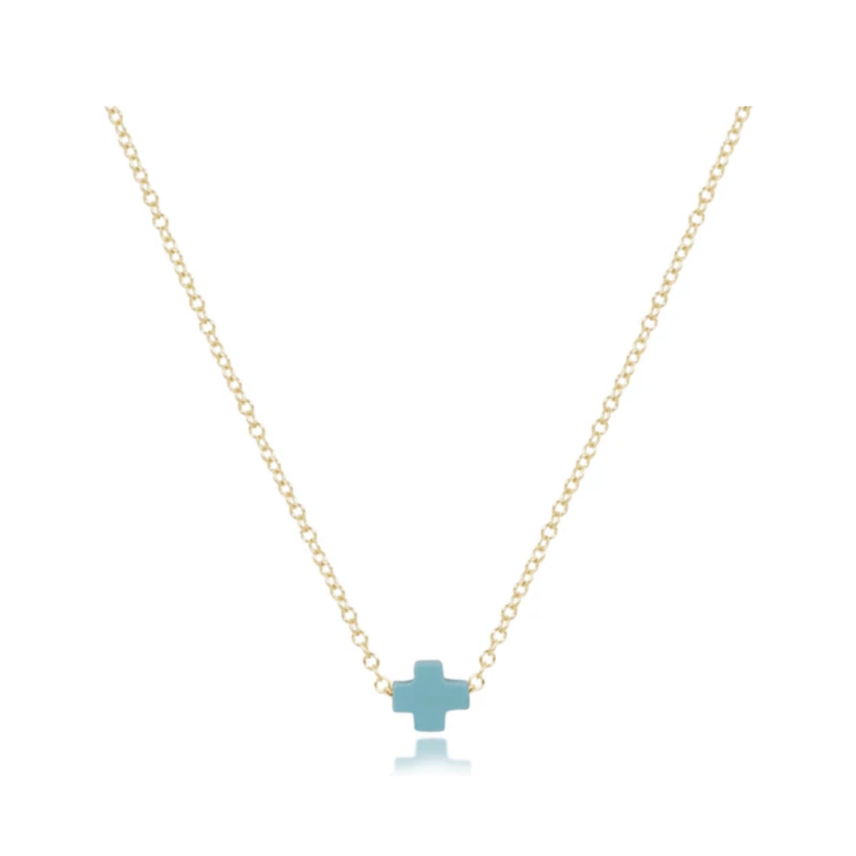 Delicate gold chain necklace featuring a small, light blue cross pendant with a subtle reflection below.