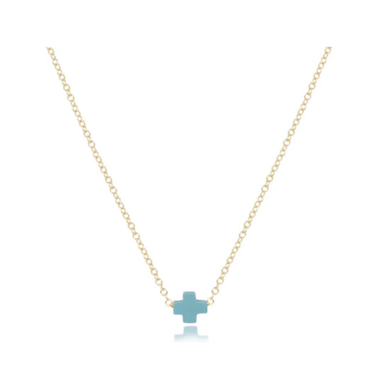 Delicate gold chain necklace featuring a small, light blue cross pendant with a subtle reflection below.