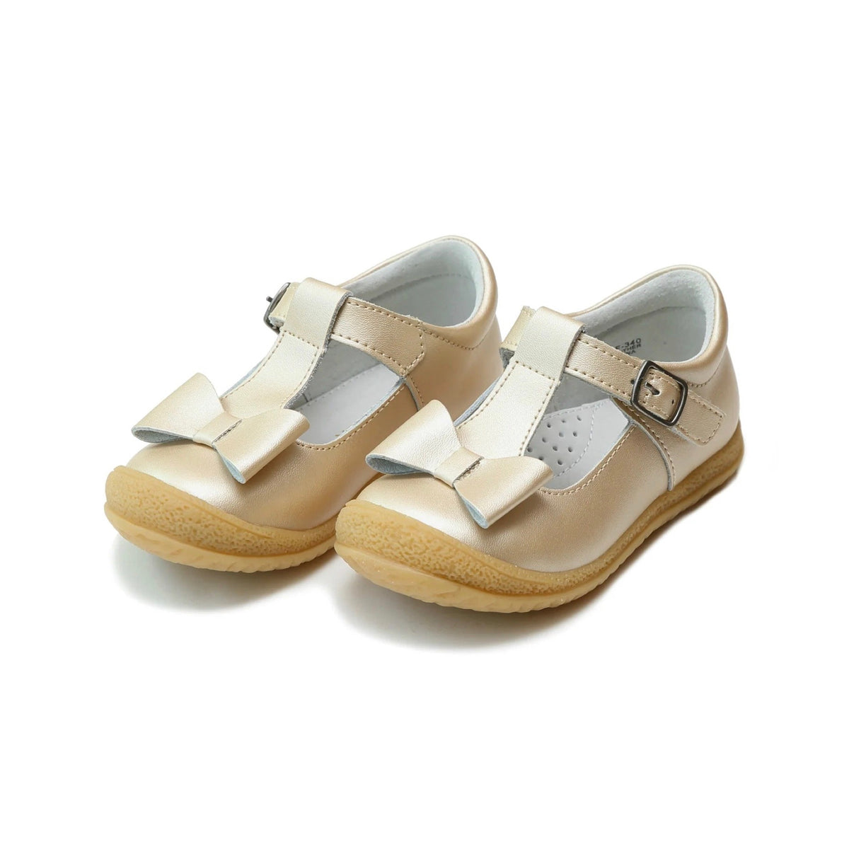 Pair of L'Amour Emma children's gold metallic T-strap shoes with a decorative bow on the toe and a textured rubber sole.