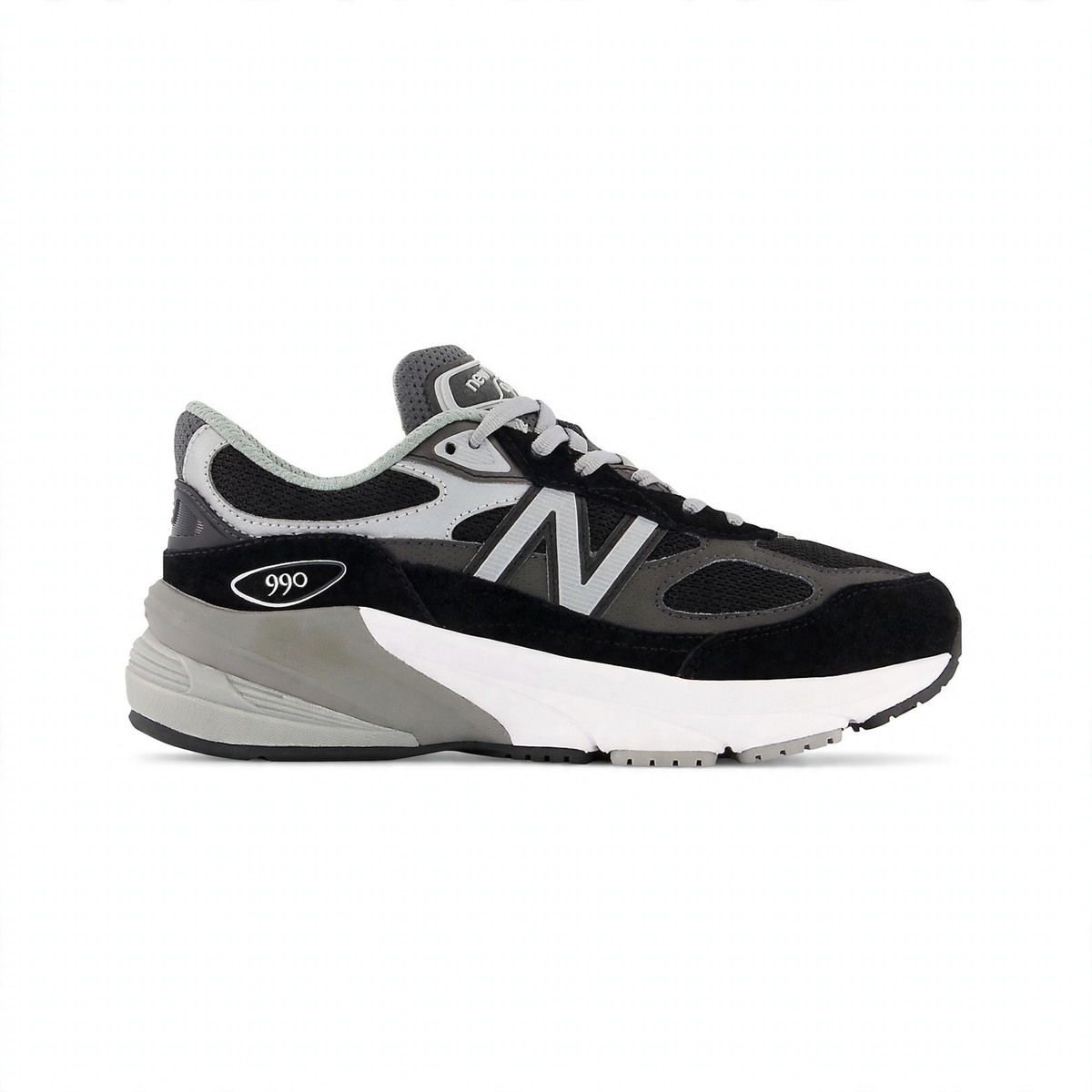 New Balance Fuelcell 990v6 Big Kids' sneaker in black and gray with white midsole, featuring a prominent "N" logo and "990" branding.