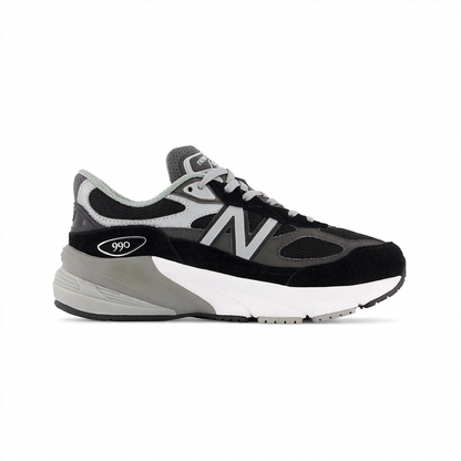 New Balance Fuelcell 990v6 Big Kids' sneaker in black and gray with white midsole, featuring a prominent "N" logo and "990" branding.