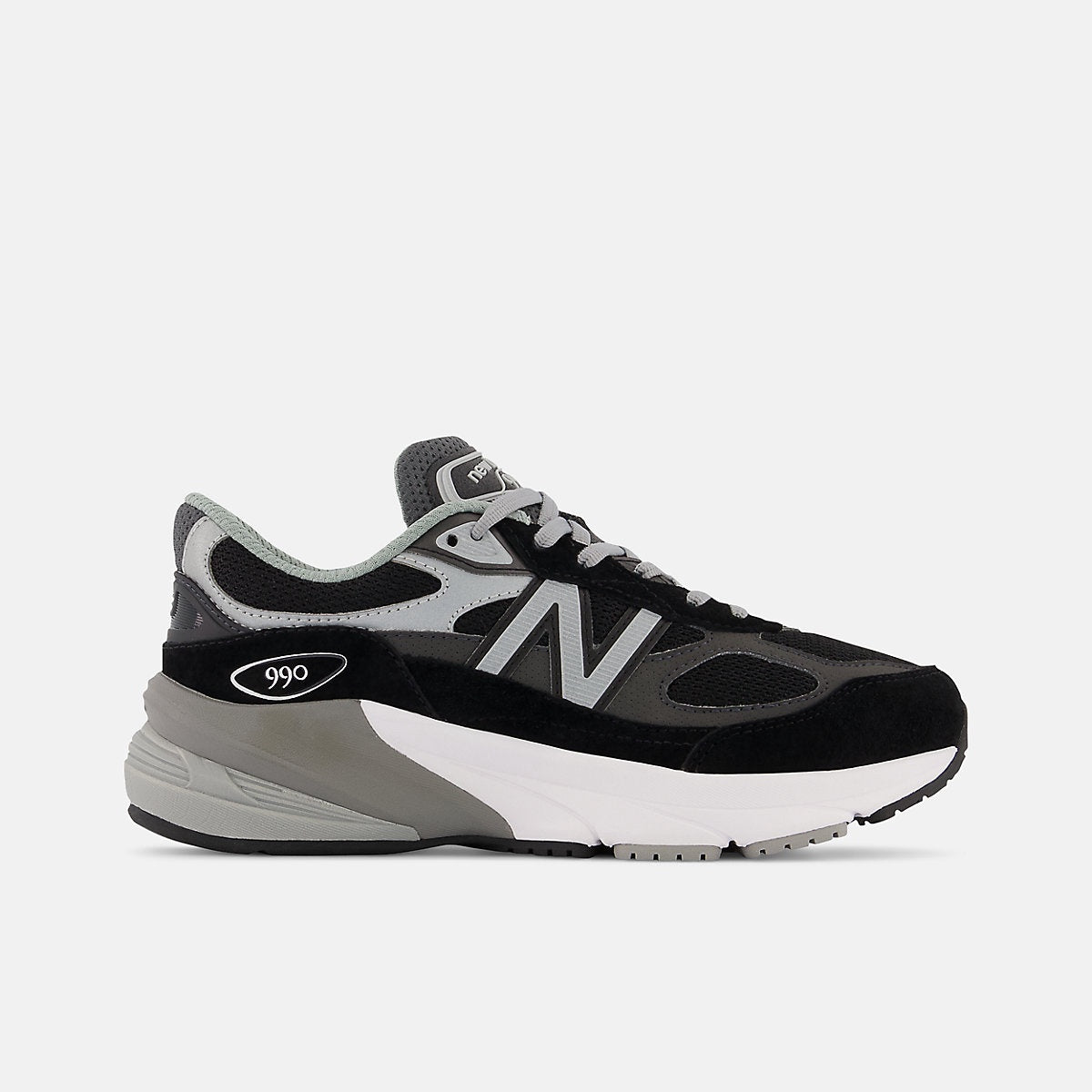 New Balance Fuelcell 990v6 Big Kids' sneaker in black and gray with white midsole, featuring a prominent "N" logo and "990" branding.
