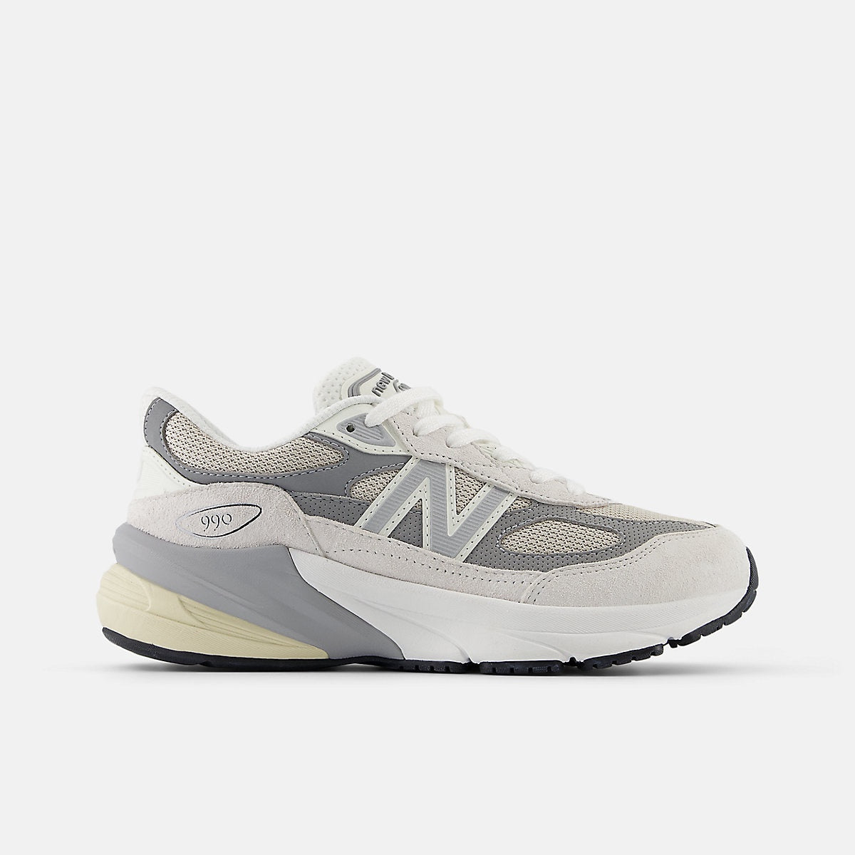 New Balance Fuelcell 990v6 big kids' sneaker in white and gray, with mesh and suede upper, 'N' logo, and '990' on the heel.