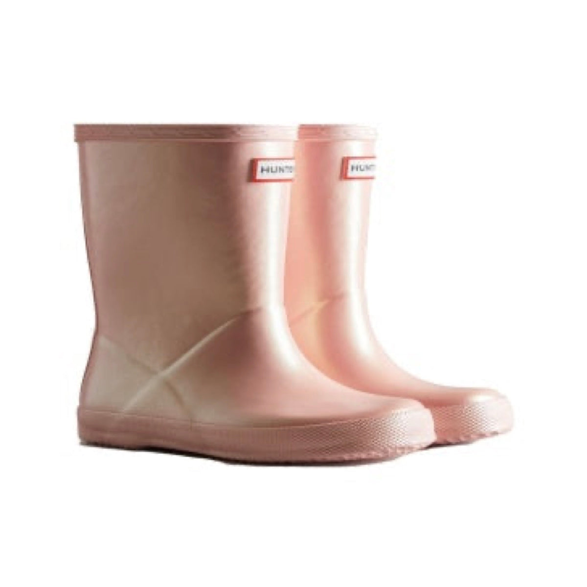 Pair of shimmery light pink Hunter Little Kids First Nebula rain boots with a short shaft and textured soles.