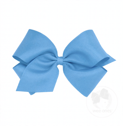 A large light blue grosgrain bow with a ribbed texture, tied in a classic shape.