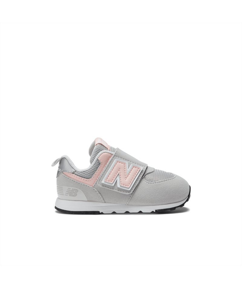 Light gray and pink New Balance 574 children's sneaker with a Velcro strap featuring the 'N' logo and an 'NB' logo on the heel.