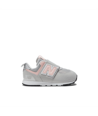 Light gray and pink New Balance 574 children's sneaker with a Velcro strap featuring the 'N' logo and an 'NB' logo on the heel.