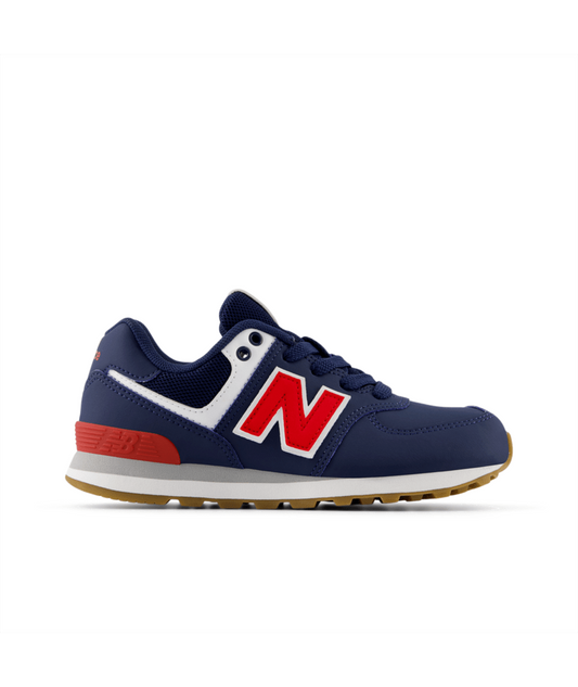 Navy blue New Balance 574 Core Lace little kids' sneaker with a red 'N' logo, white trim, red heel accent, and brown sole.