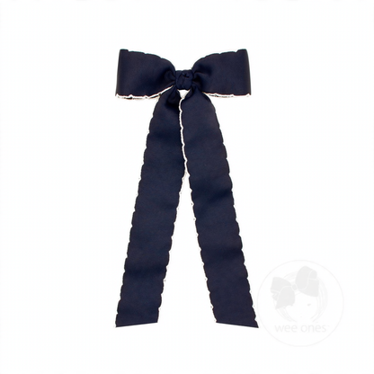 Navy blue grosgrain hair bow with white moonstitch edges, a knot wrap, and long streamer tails.