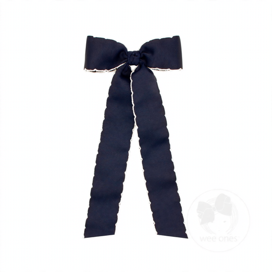 Navy blue grosgrain hair bow with white moonstitch edges, a knot wrap, and long streamer tails.