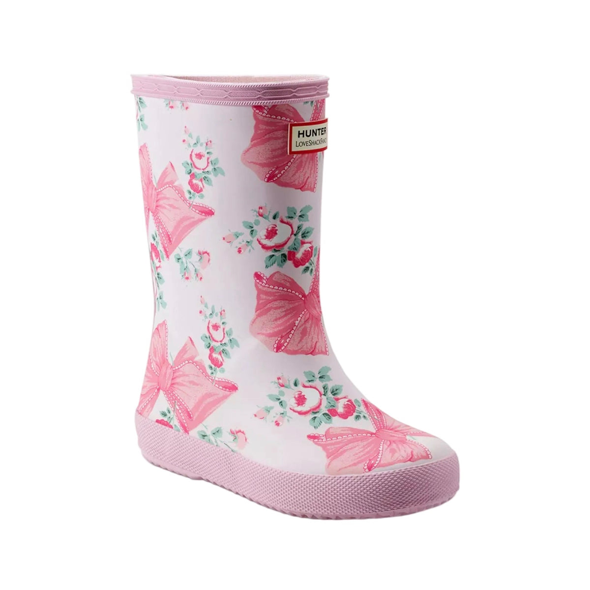 Pink and white Hunter x LoveShackFancy Kids' First Classic Rain Boot with a floral and bow pattern.