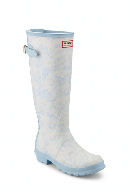 Tall white rain boot with light blue floral pattern, light blue trim, adjustable back buckle, and Hunter x LoveShackFancy logo.