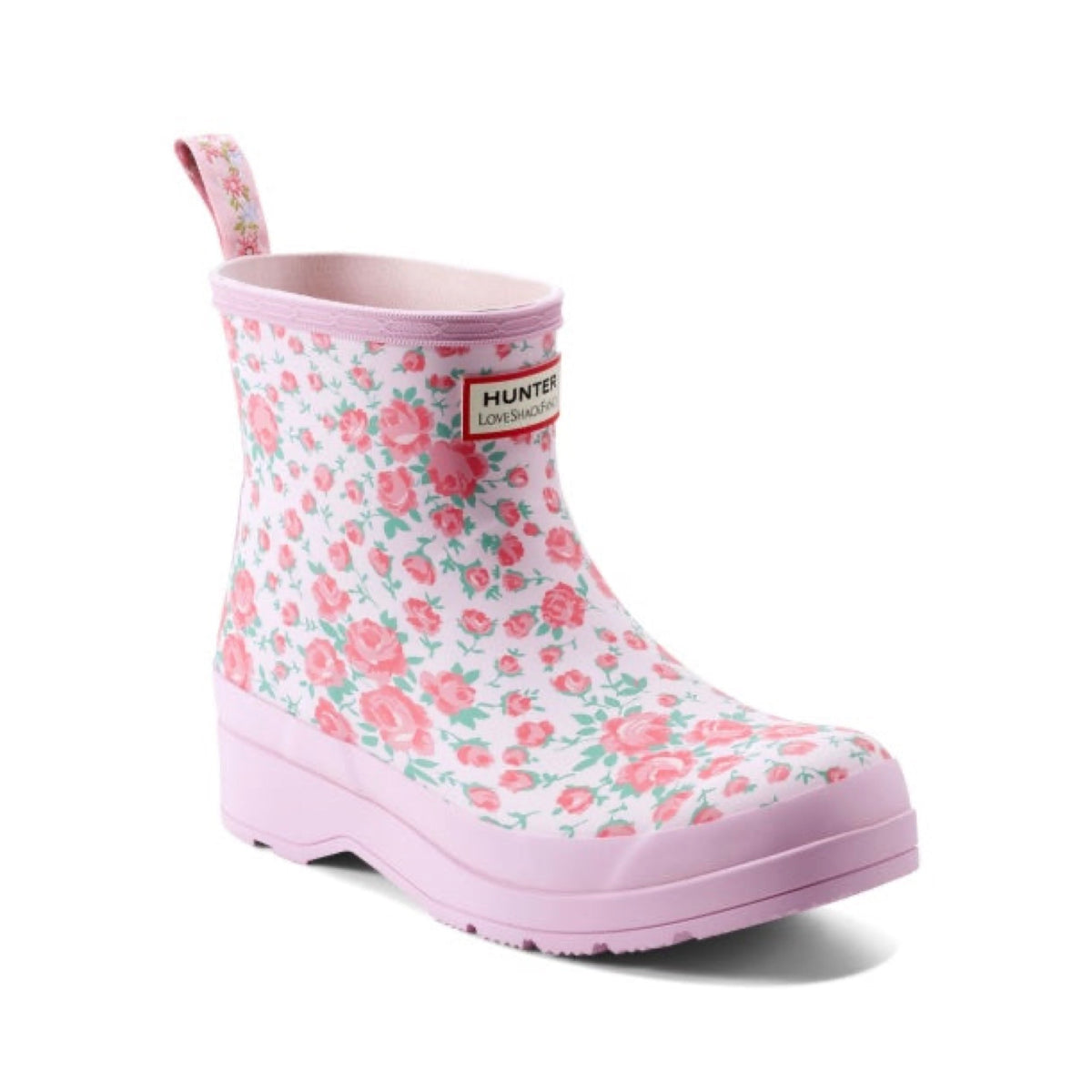 Pink floral Hunter x LoveShackFancy short rain boot with a rose pattern, pink sole, and a pull tab.