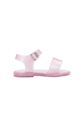 Sparkly pink translucent jelly sandals for babies with an ankle strap and silver buckle.