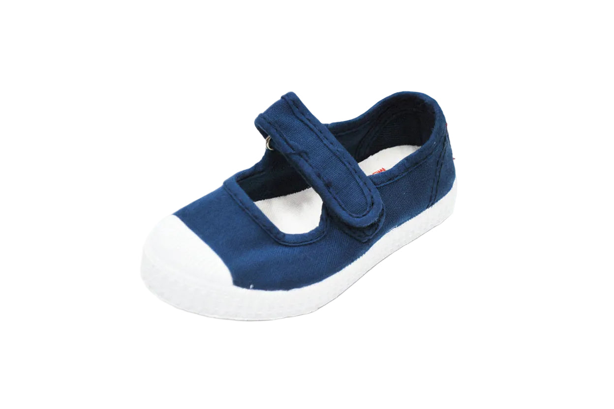 A navy blue canvas Mary Jane-style shoe with a white rubber toe cap and sole, shown on a clean white background. 